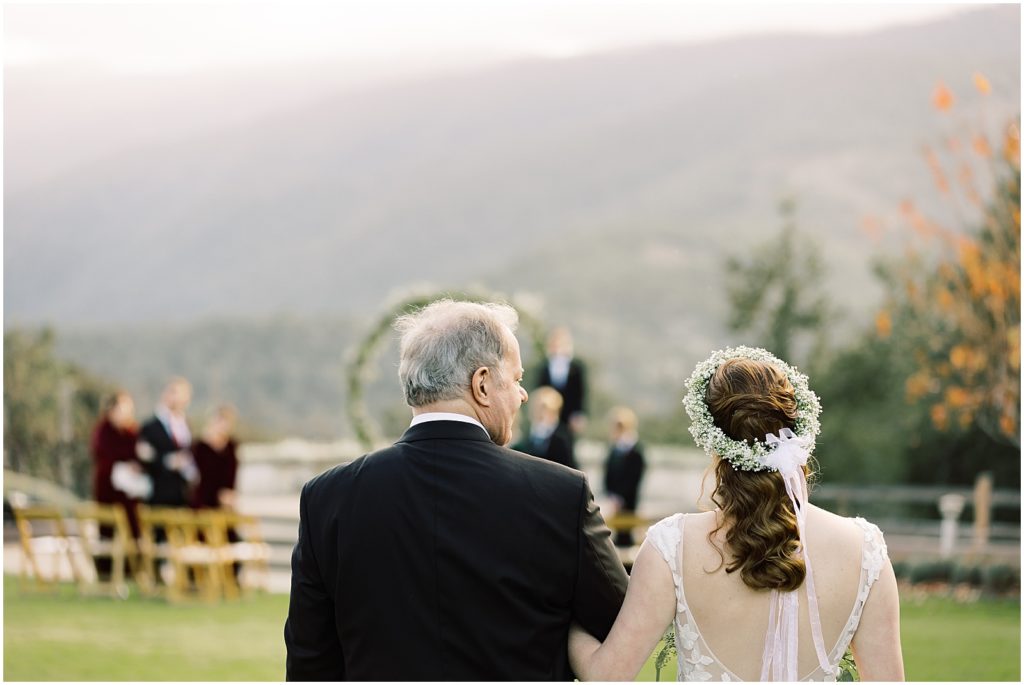 a bride and her father walking down the aisle