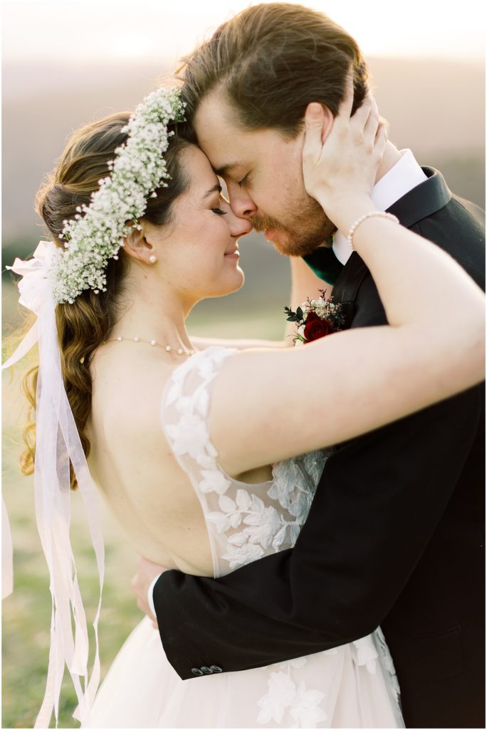 a bride and groom embracing one another, head to head
