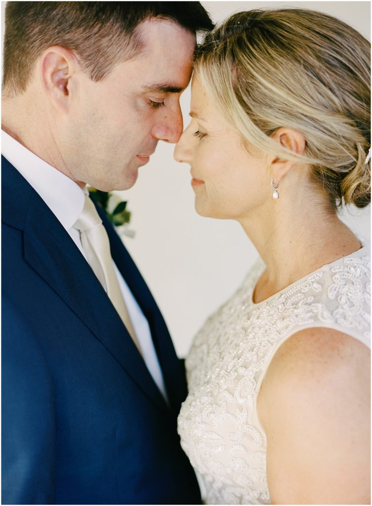 portrait of the bride and groom nose to nose photographed by Monterey wedding photographer