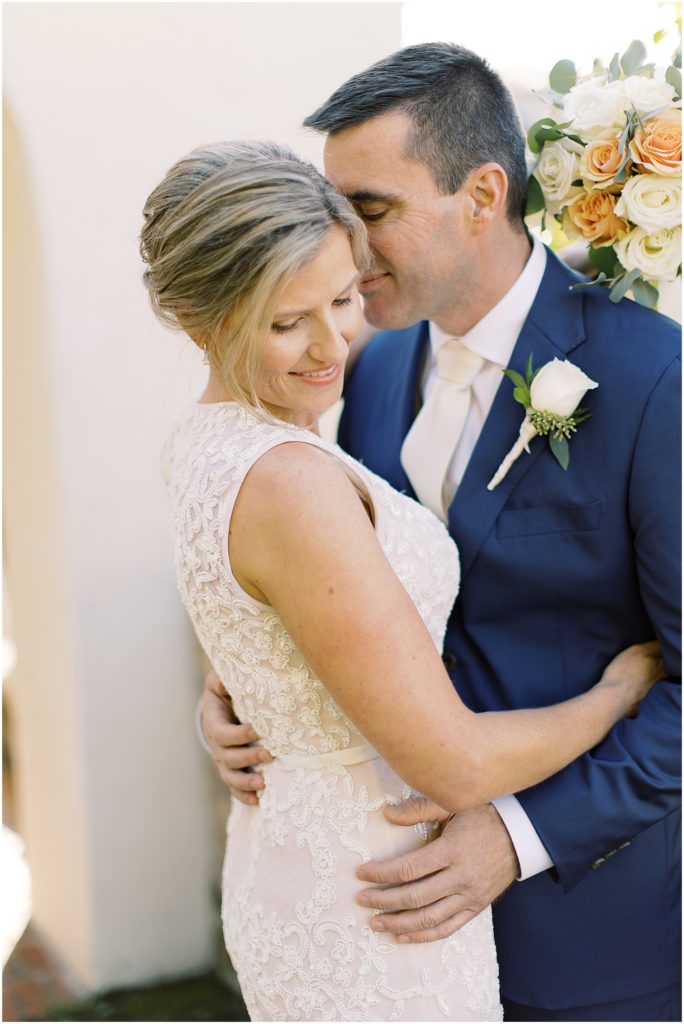 bride and groom embracing each other photographed by Monterey wedding photographer