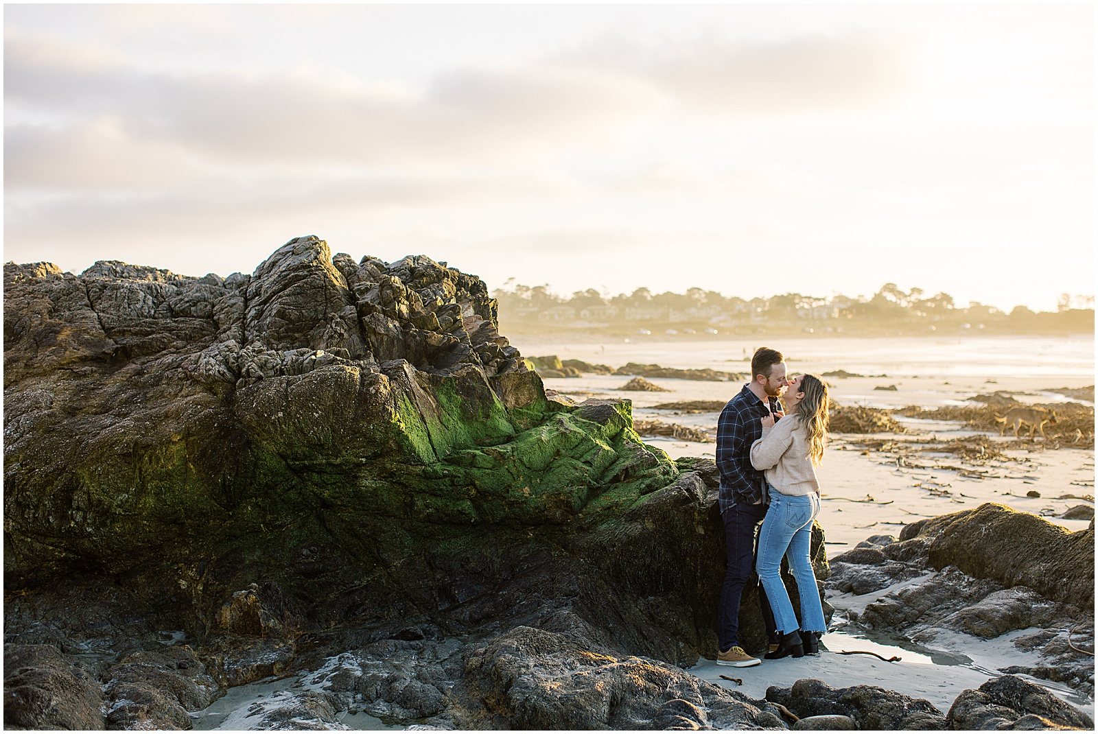 couple kissing on the beach for Pebble Beach engagement