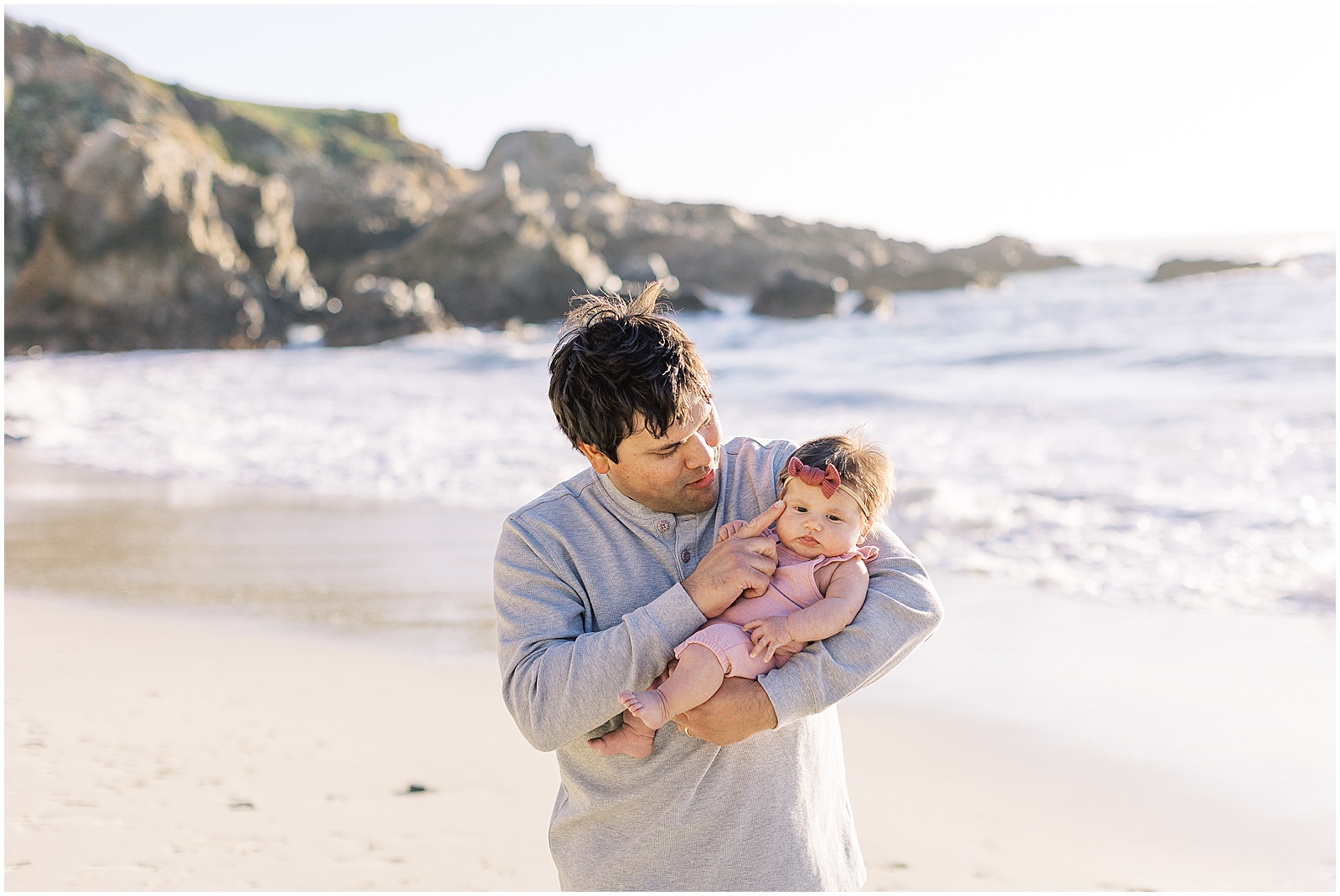 portrait of a father holding his newborn for Big Sur family shoot