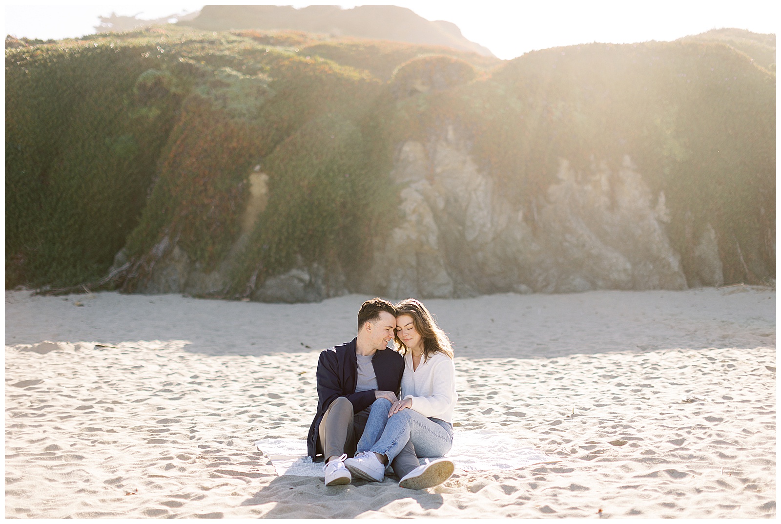 couple sitting on the beach after Big Sur Proposal