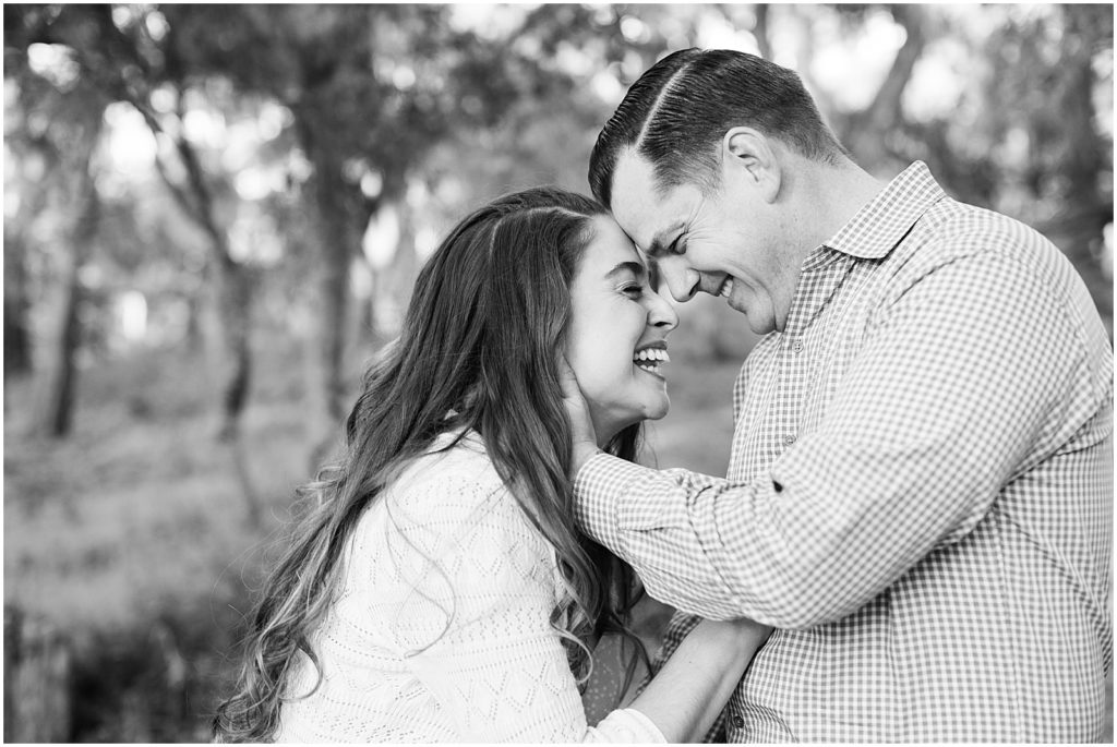 black and white portrait of a couple laughing together during Pebble Beach engagement shoot