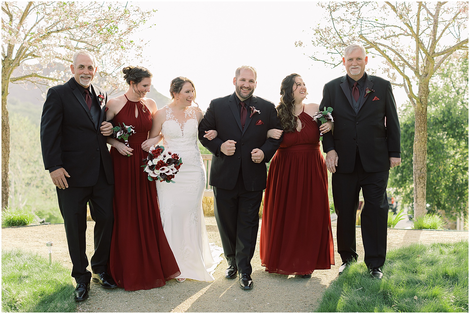 Groom, bride and bridal party walking together during Monterey wedding day