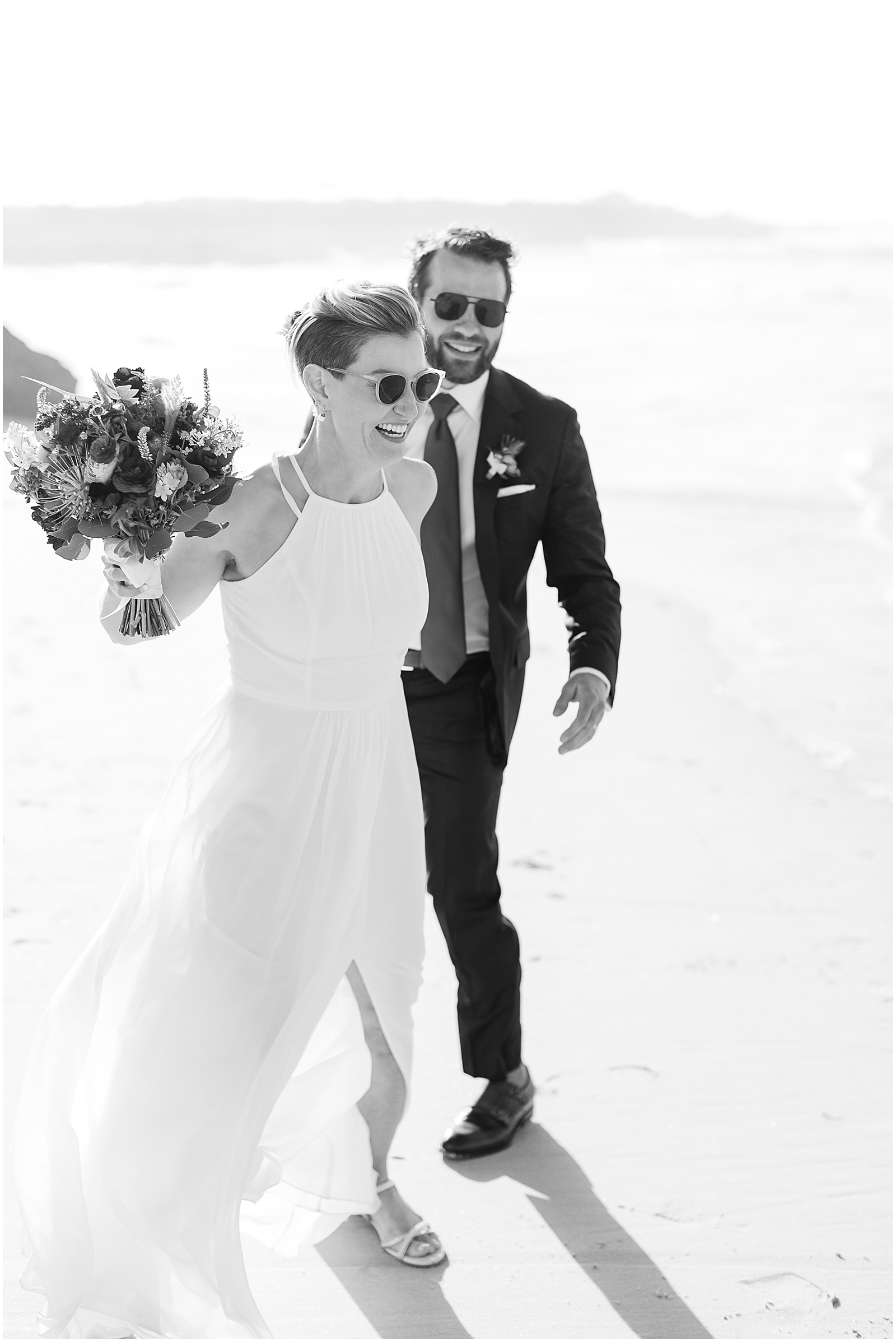 black and white portrait of bride and groom wearing sunglasses