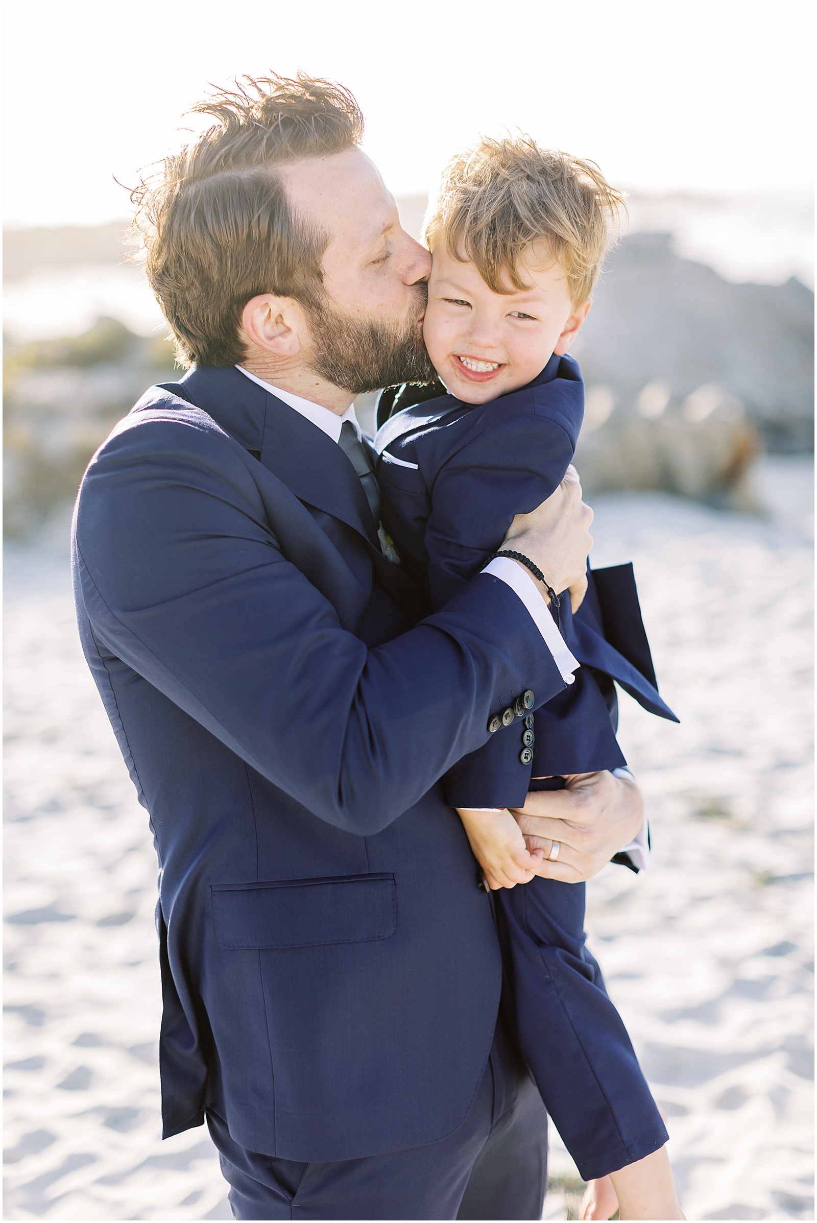 groom kissing his son on the cheek