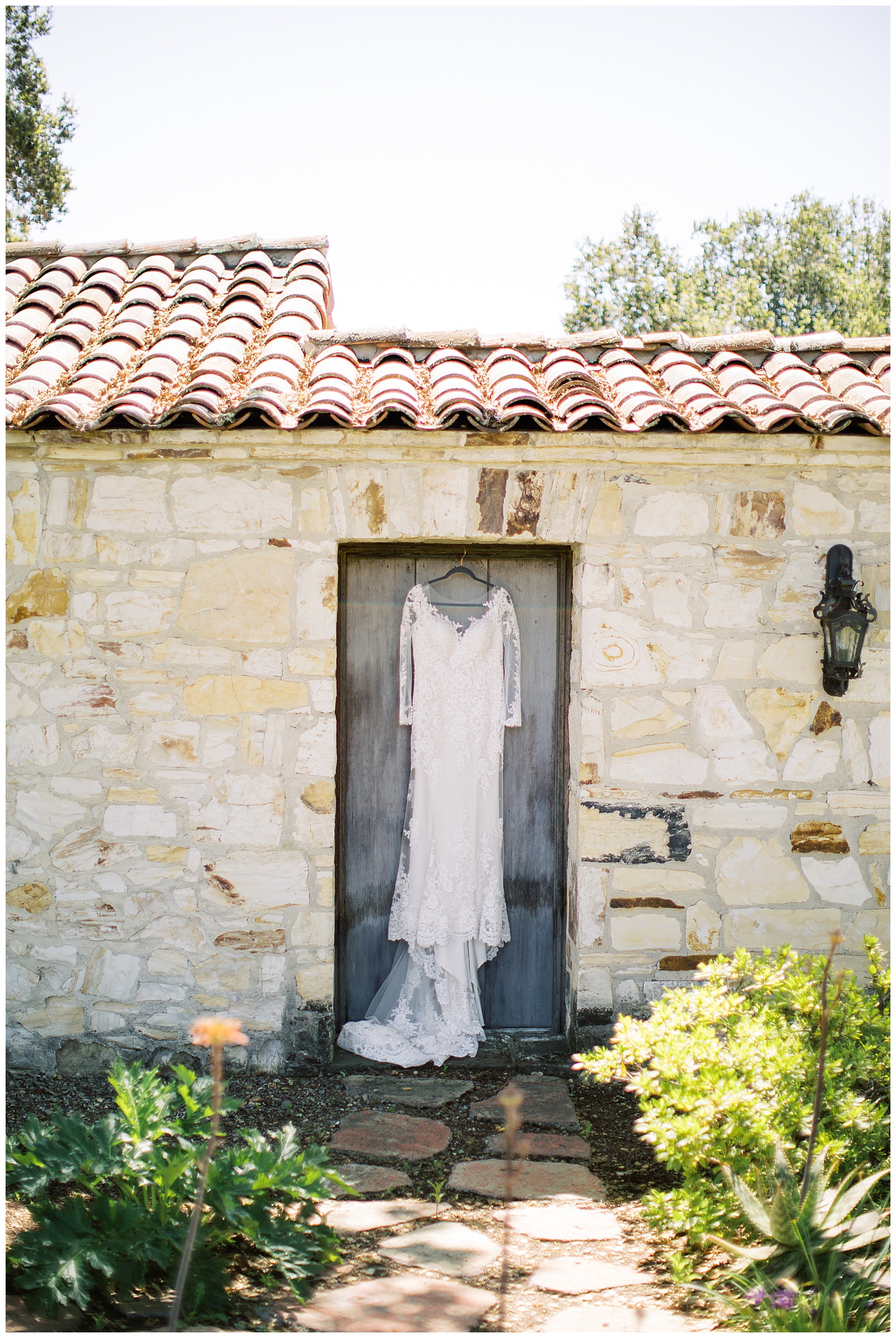 a dress hanging on a door at Holman Ranch wedding