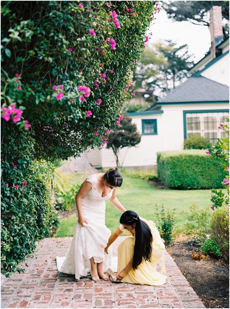 portrait of bridesmaid with bride adjusting her dress by film photographer AGS Photo Art 