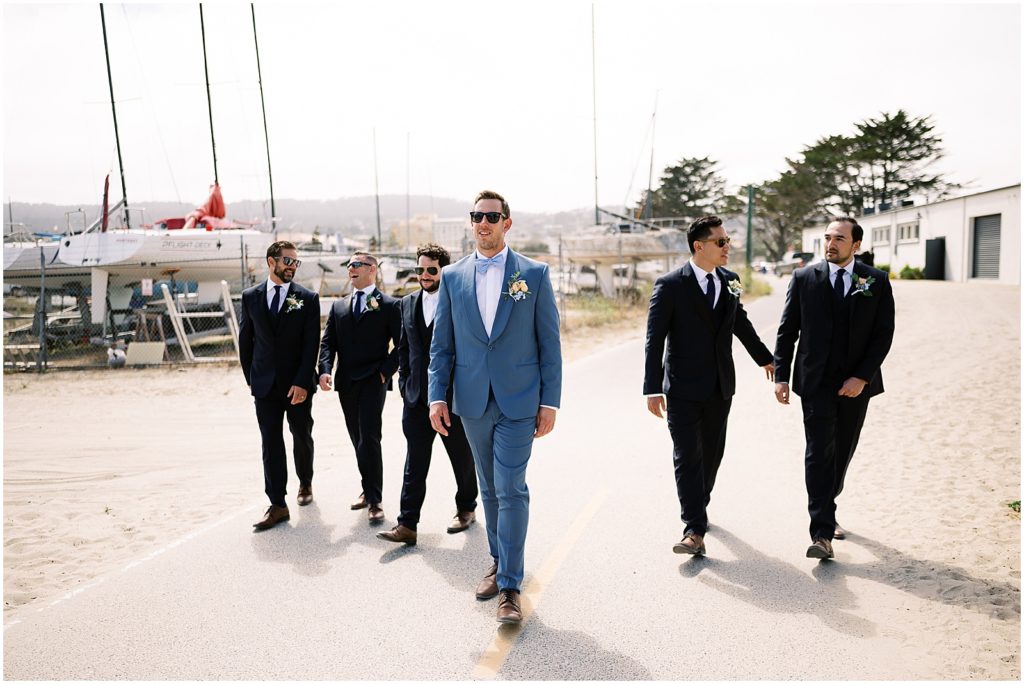 portrait of groom walking with groomsmen by film photographer AGS Photo Art
