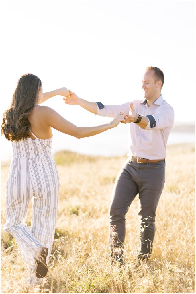 portrait of engaged couple slow dancing in field by film photographer AGS Photo Art
