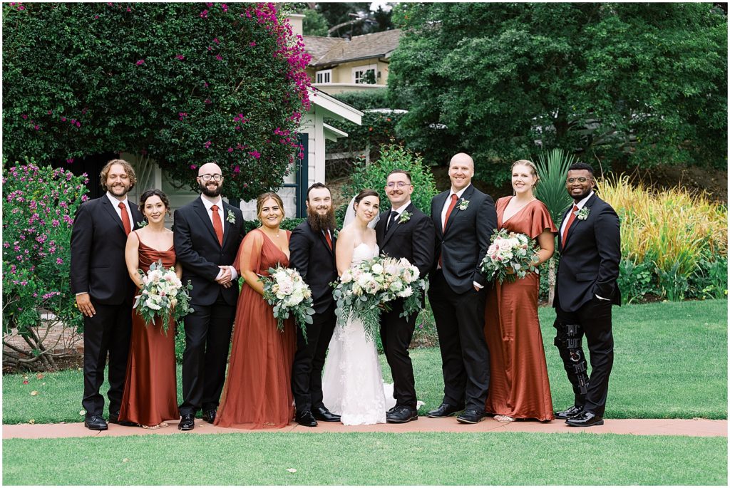 portrait of full bridal party standing in front of venue by film photographer AGS Photo Art