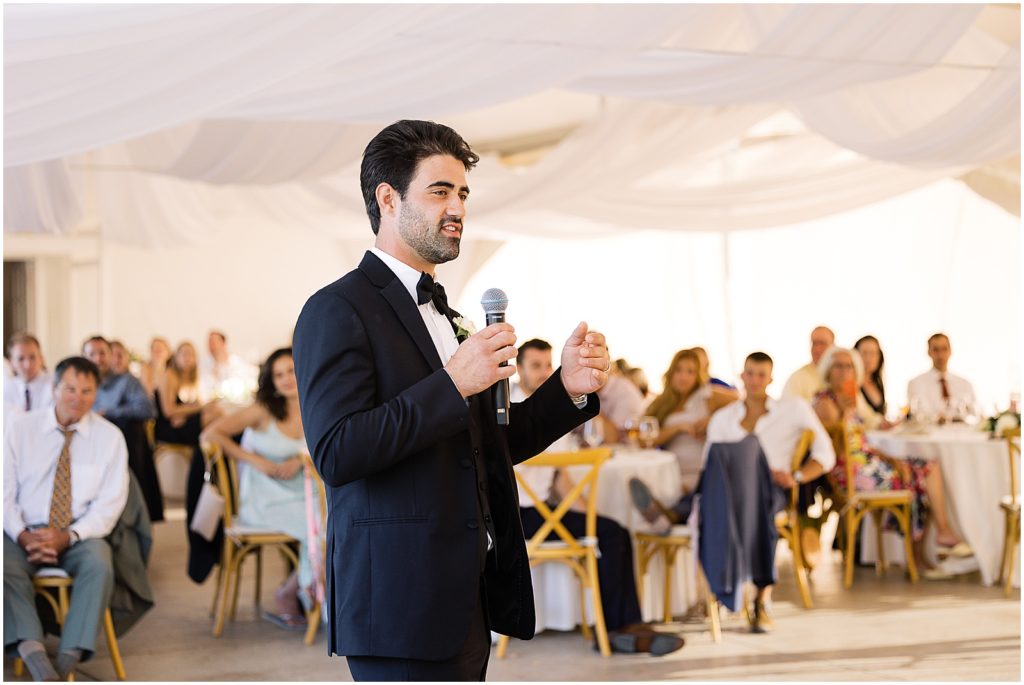 portrait of groom giving speech during reception by film photographer AGS Photo Art