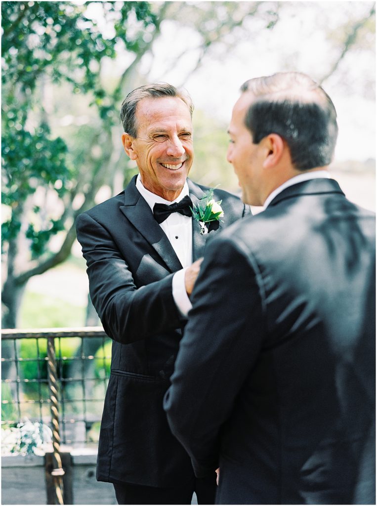 portrait of groom and father fixing bow tie by film photographer AGS Photo Art