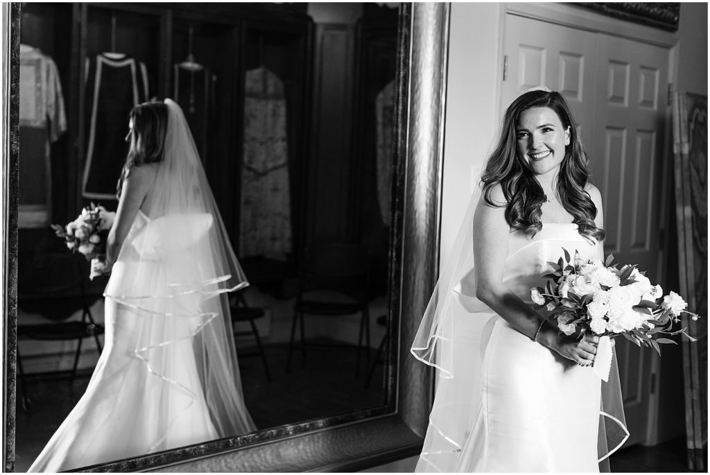 portrait of bride standing in front of mirror in bridal gown by film photographer AGS Photo Art
