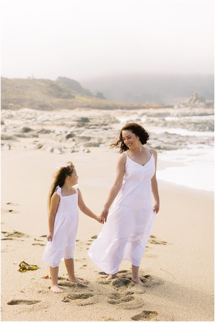 portrait of mother and daughter holding hands wearing white dresses on beach by film photographer AGS Photo Art
