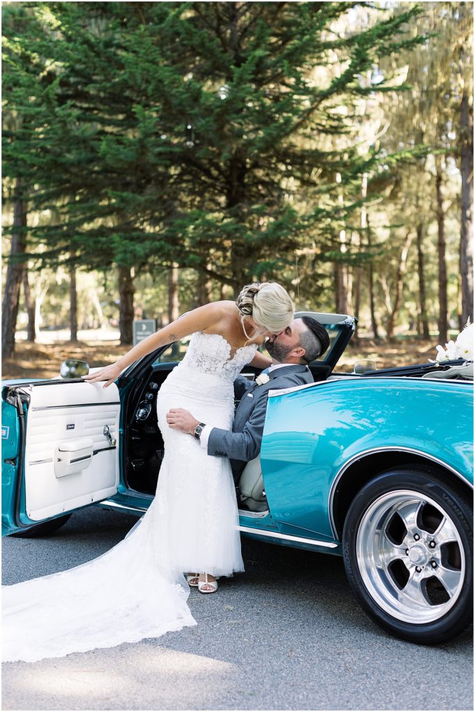 portrait of bride and groom sitting in blue car by film photographer AGS Photo Art