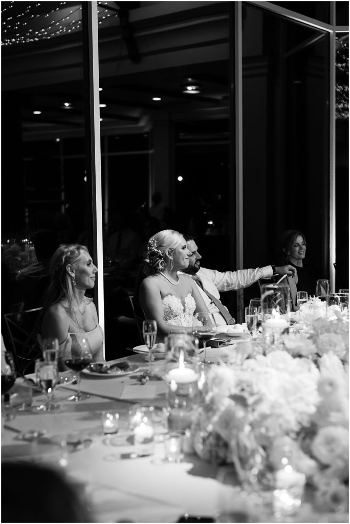 portrait of bride and groom sitting at the table with bridal party by film photographer AGS Photo Art