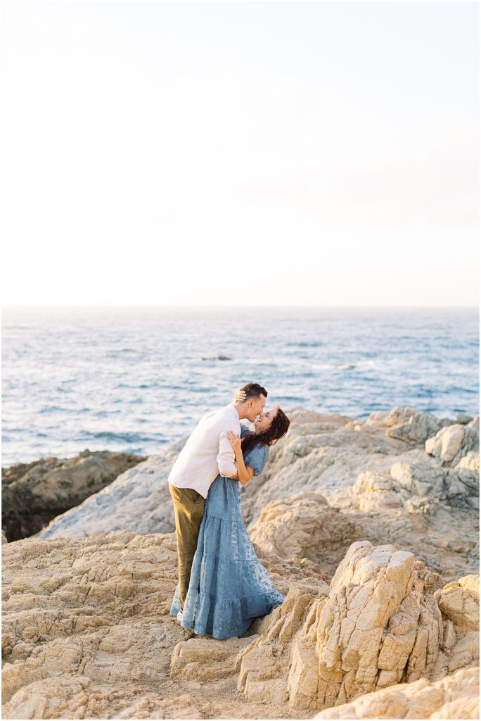 portrait of couple posing on rock in front of ocean by film photographer AGS Photo Art