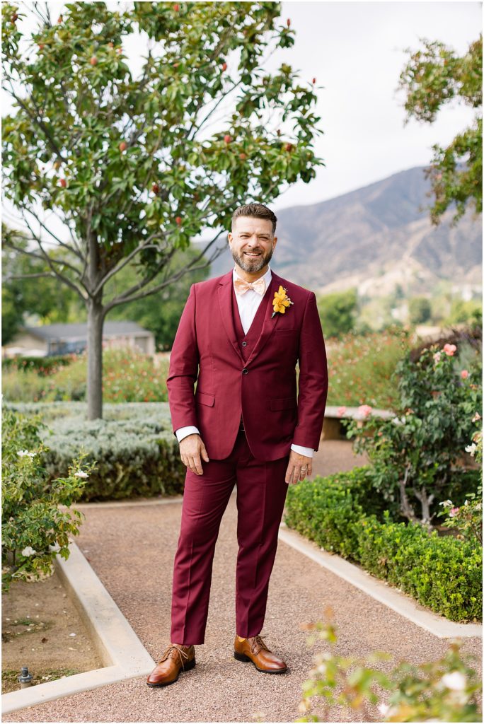 portrait of groom standing surrounded by the garden and trees by film photographer AGS Photo Art