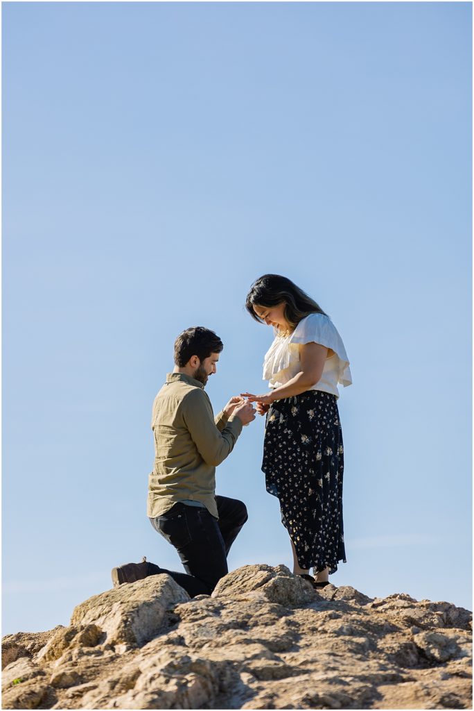 portrait of man on knee proposing to girl on mountain by film photographer AGS Photo Art