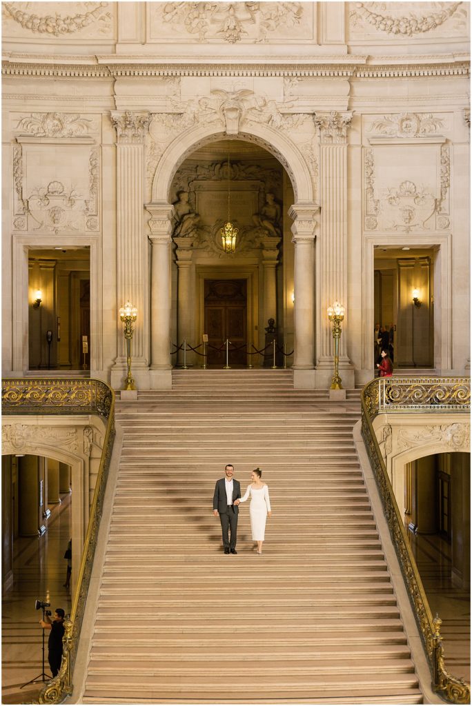 portrait of couple walking down grand staircase in city hall by film photographer AGS Photo Art