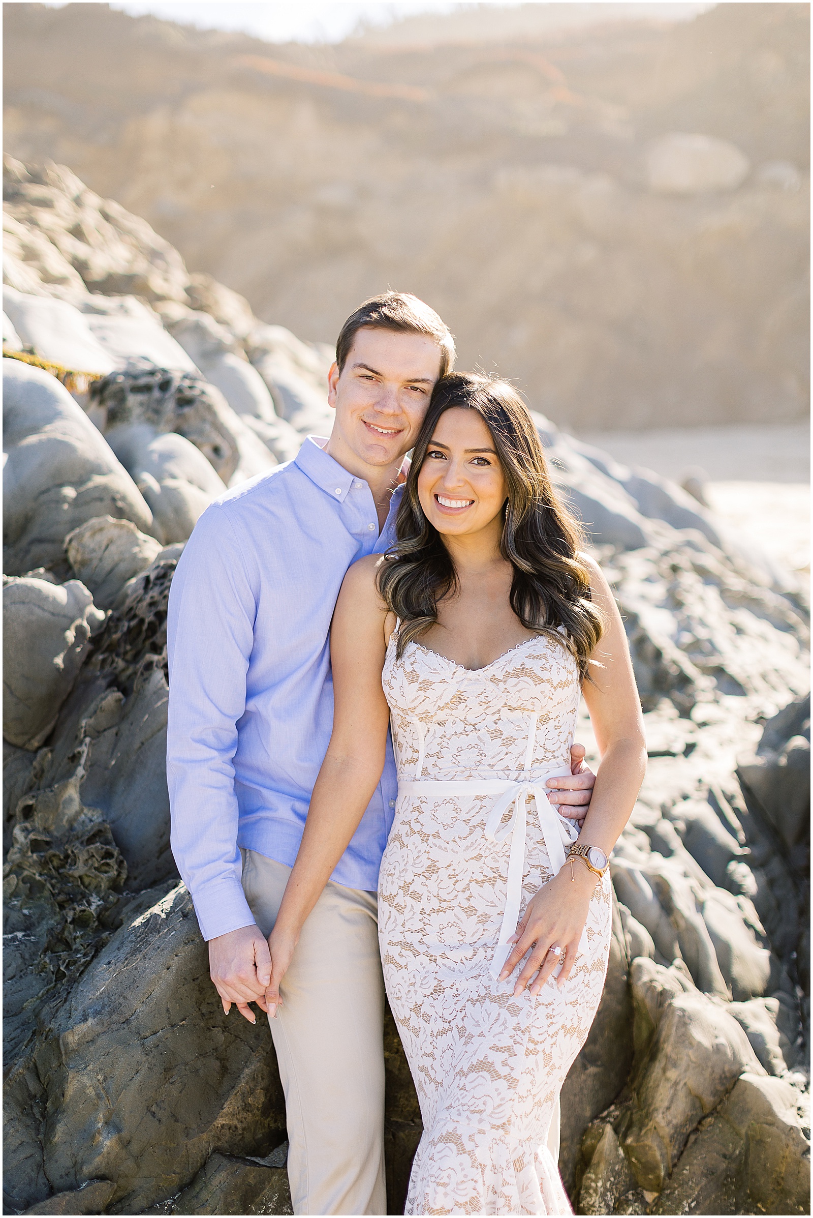 portrait of couple posing in front of rocks by the ocean by film photographer AGS Photo Art
