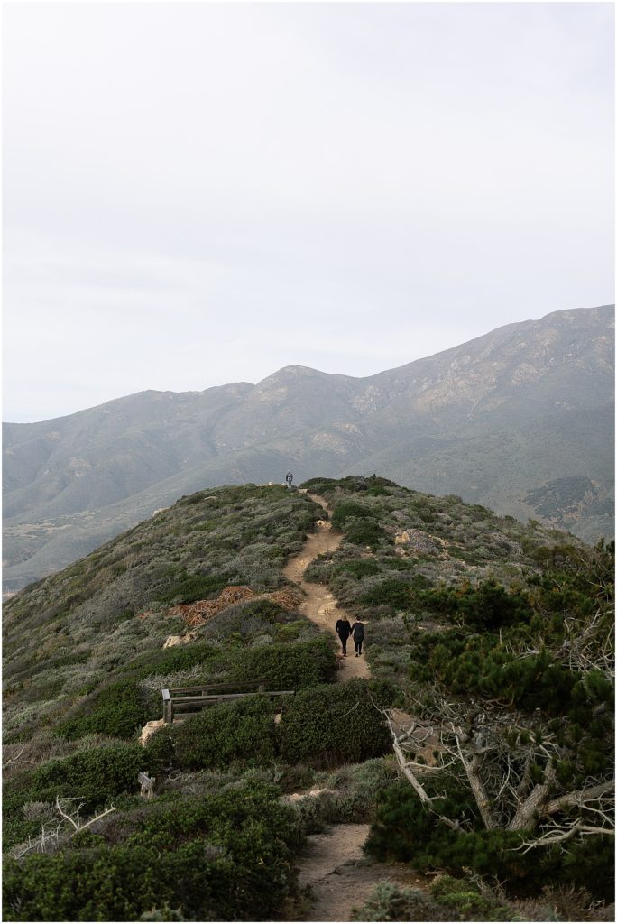 portrait of couple walking up trail to mountain peak by film photographer AGS Photo Art