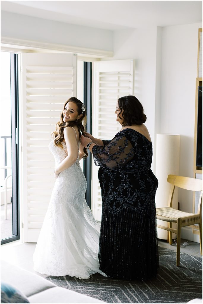 portrait of mother fixing bridal gown on bride by film photographer AGS Photo Art