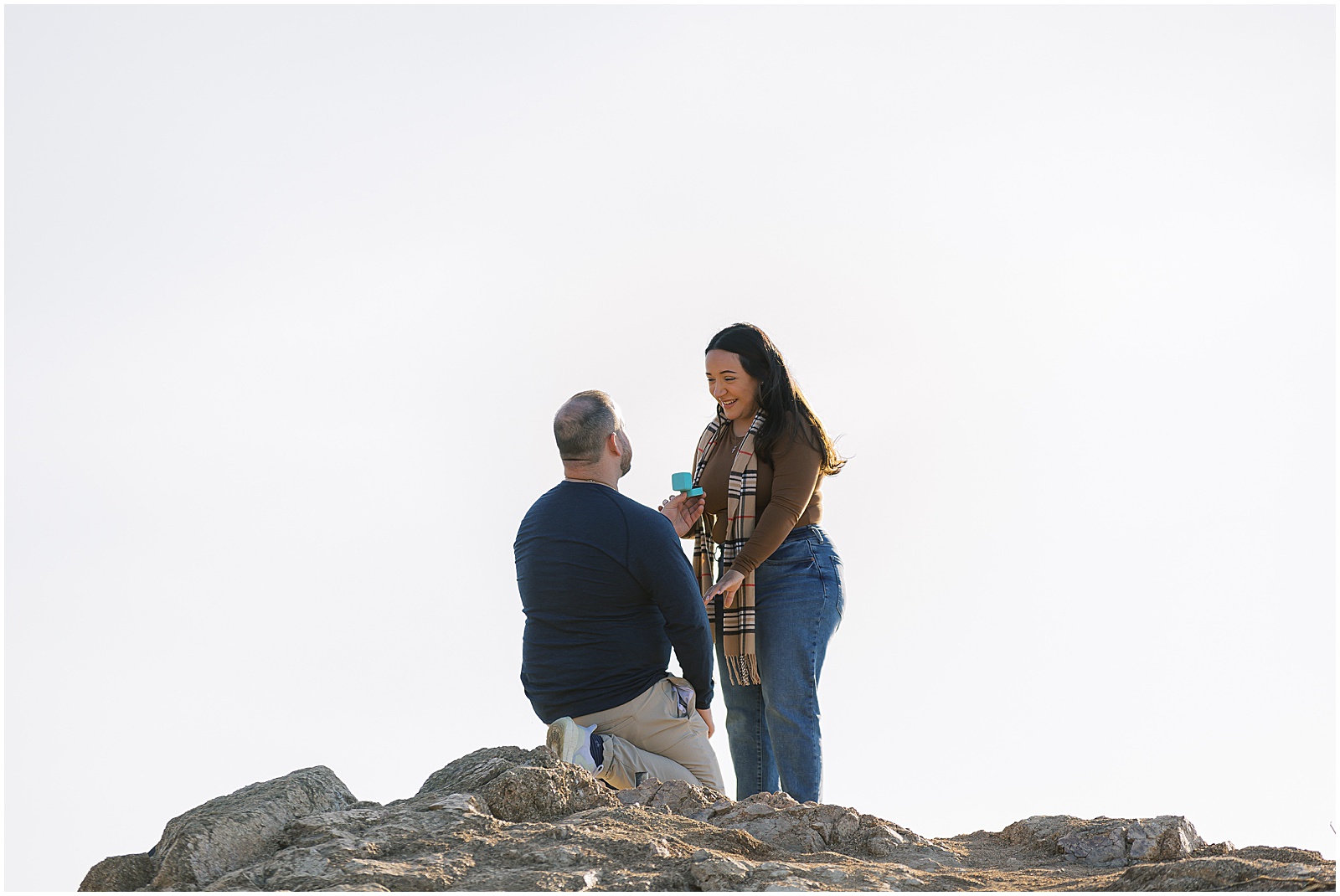 portrait of engaged couple standing at the peak of a mountain by film photographer AGS Photo Art