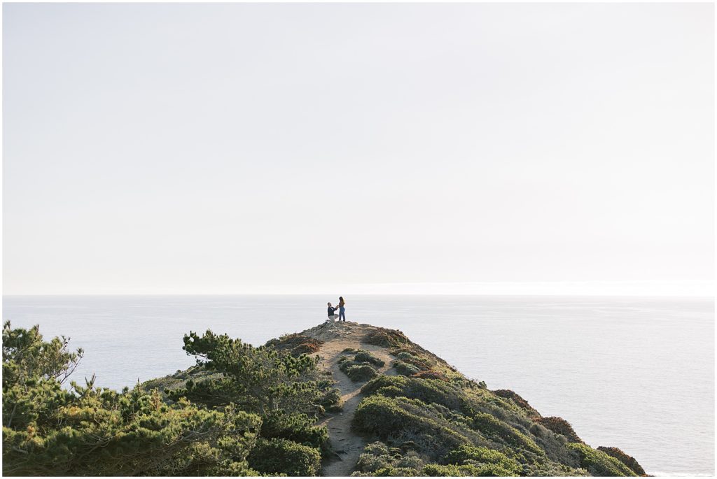 portrait of couple standing at mountain peak on the coast by film photographer AGS Photo Art