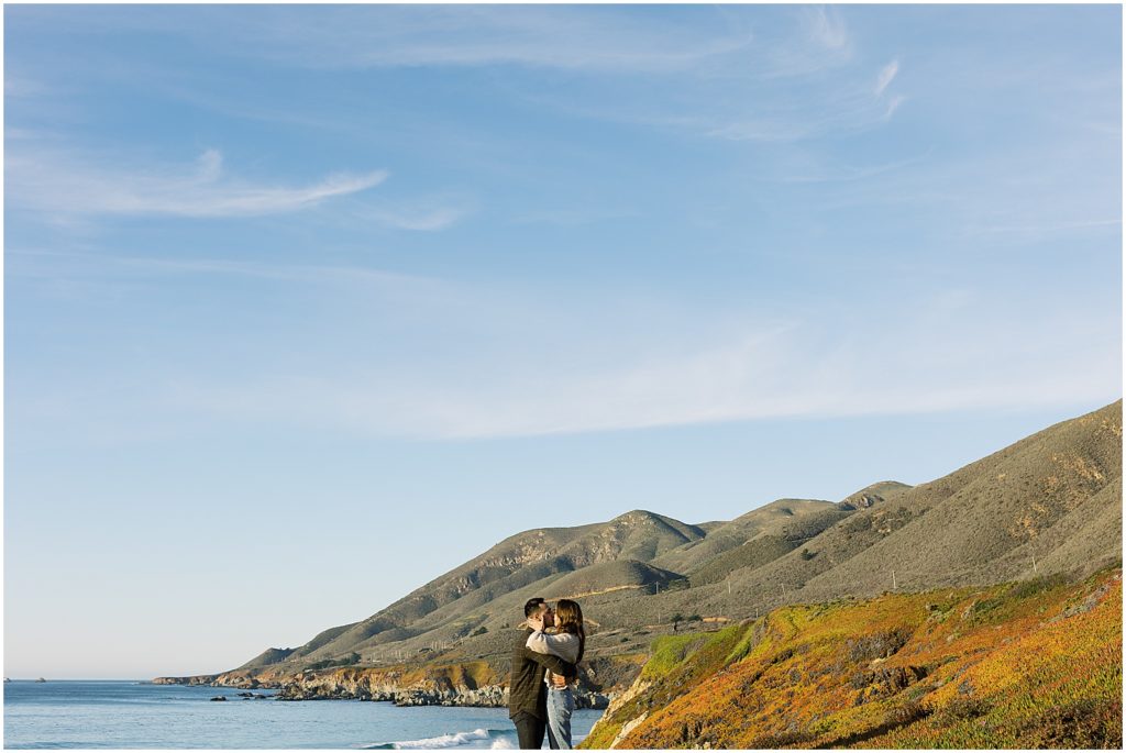 portrait of couple during surprise proposal standing on the coastline by film photographer AGS Photo Art