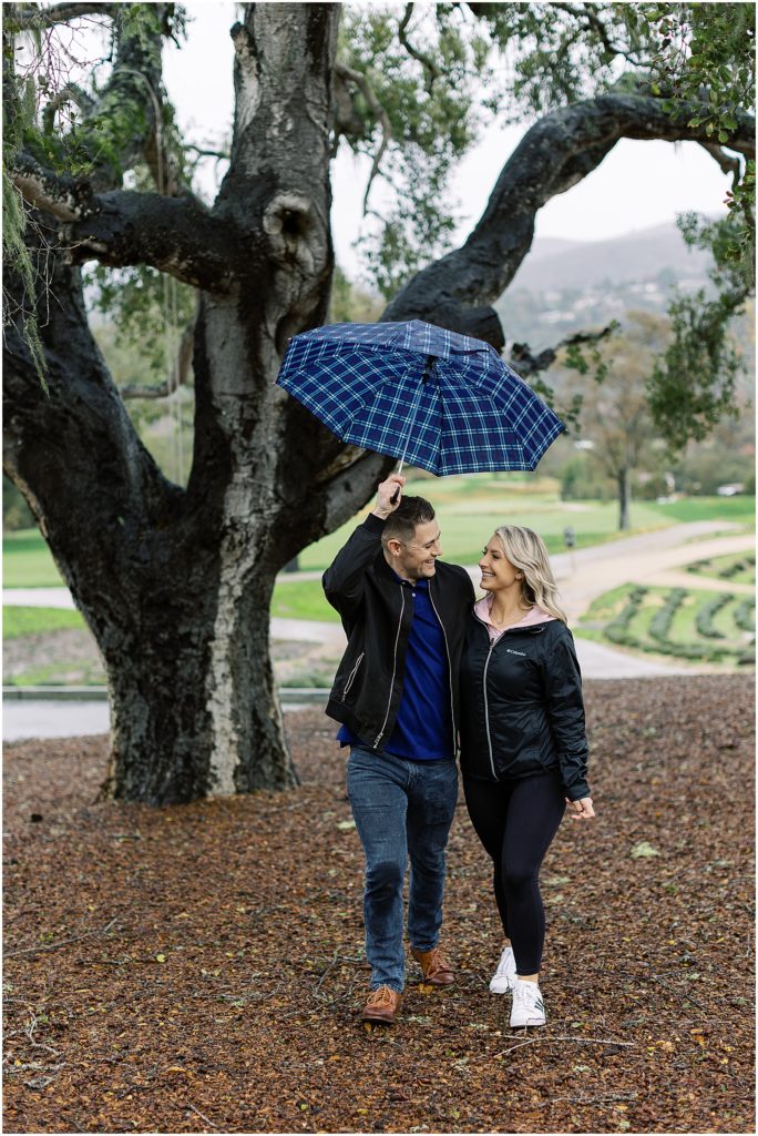 portrait of couple taking a stroll in the park with umbrella by film photographer AGS Photo Art