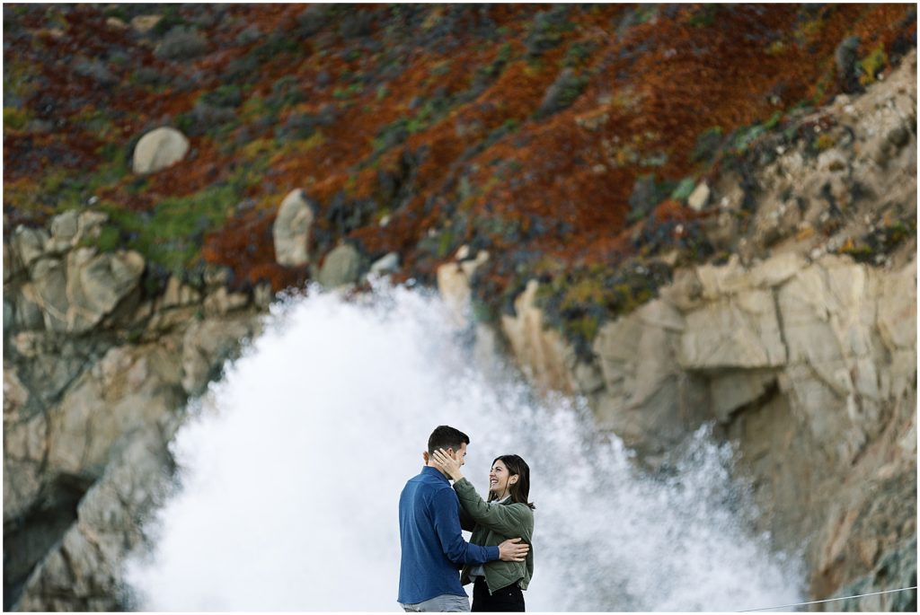 portrait of couple standing in front of waterfall and cliffs by film photographer AGS Photo Art