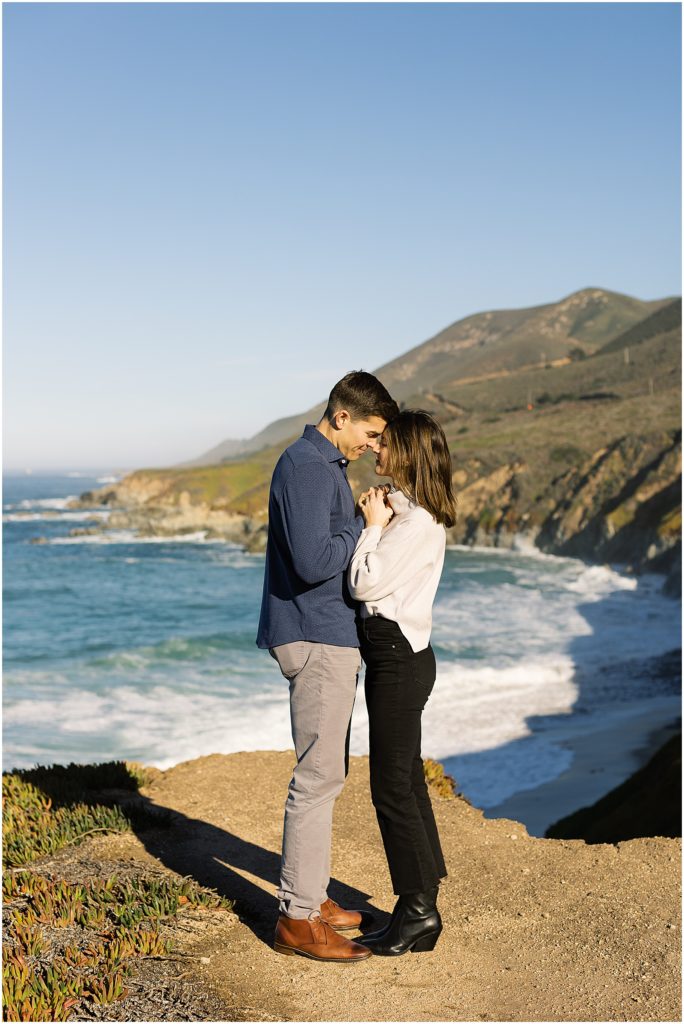 portrait of couple standing on mountain along the coastline by film photographer AGS Photo Art
