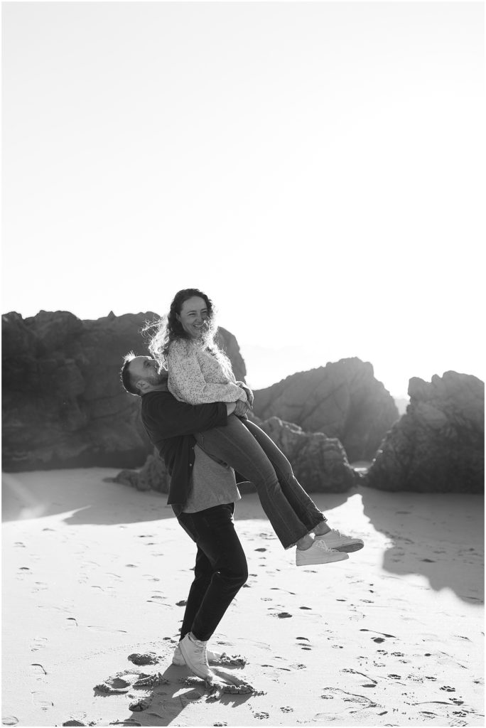 portrait of couple playing on the beach during engagement by film photographer AGS Photo Art