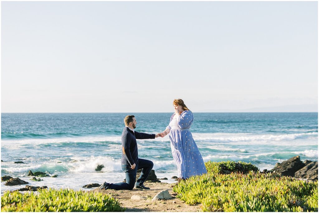 photo of a surprise proposal in Big Sur, a man getting down on one knee with the beautiful Big Sur coastline behind them
