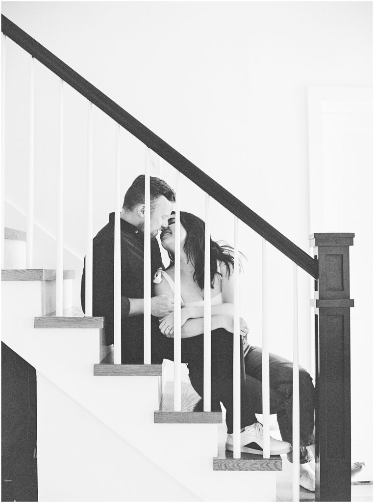 Black and White B&W film portrait photograph of engaged couple with their fixer upper project house, building their dream home with photography by AGS Photo Art