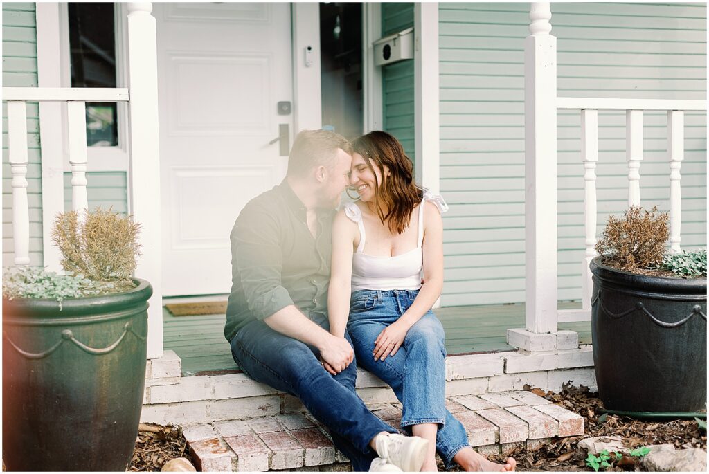 Couple in front of their fixer upper project house, building their dream home with photography by AGS Photo Art