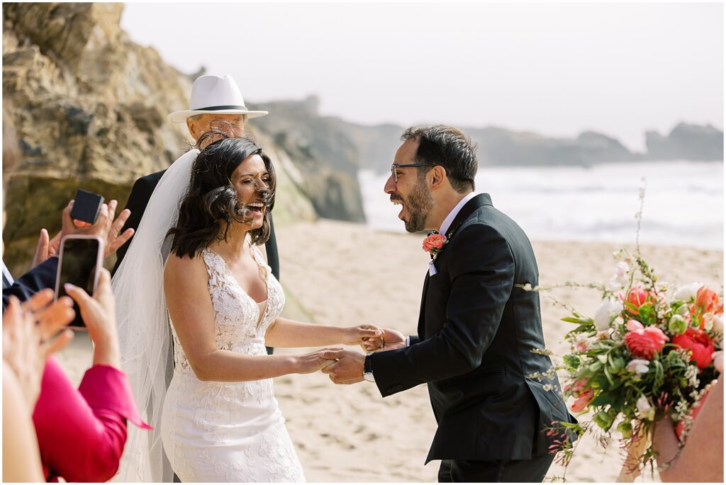 Newlyweds laughing on the beach in Big Sur, California by Carmel photographer AGS Photo Art