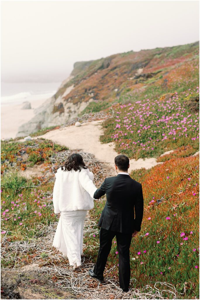 Newlyweds walking along the Big Sur coast. Photography by AGS Photo Art