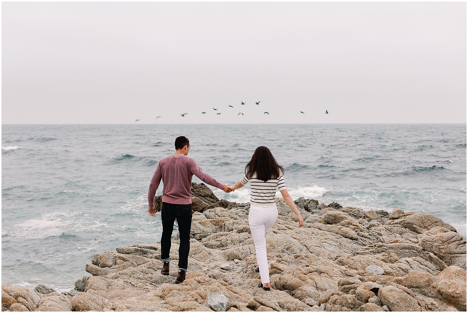 Couple walks along the rocky coast of Big Sur for their Engagement photoshoot with AGS Photo Art
