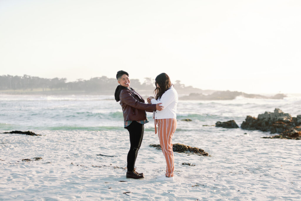 Couple celebrating with one another during Carmel engagement photo session.