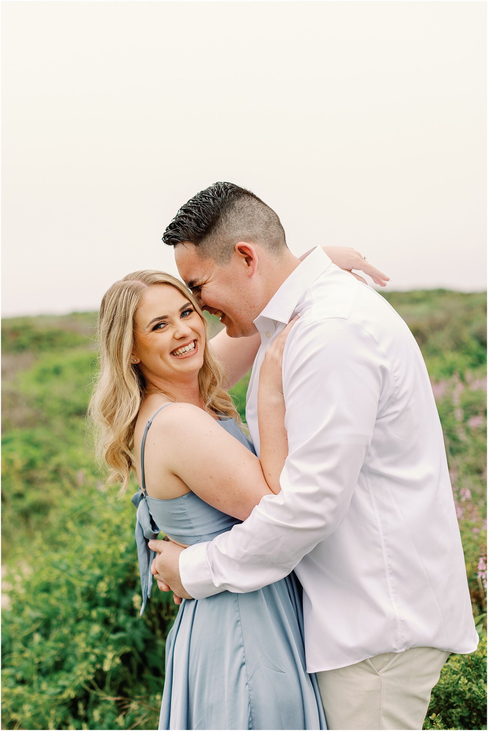 Laughing candid moment of couple during Carmel Coast engagement session