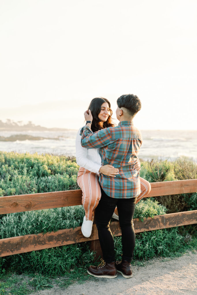 Joyful couple smiling during inclusive engagement session in Monterey Bay.