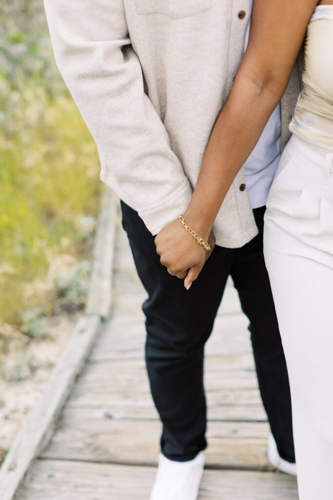 Radiant cut diamond engagement ring in a pavé setting on Jessica’s hand.