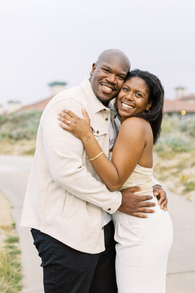 Romantic hug after their proposal at Spanish Bay in Pebble Beach.