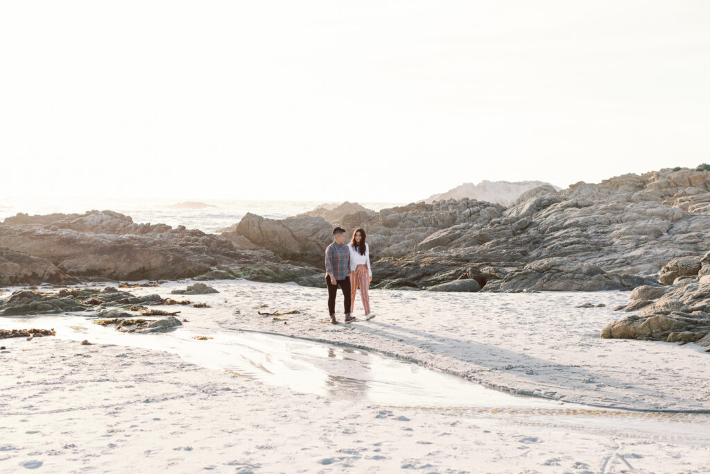 Two brides-to-be celebrating engagement by walking on the Carmel coast.