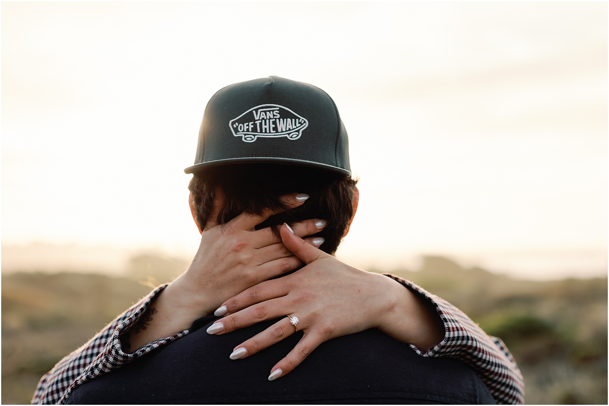 Engagement ring detail on simple gold band.