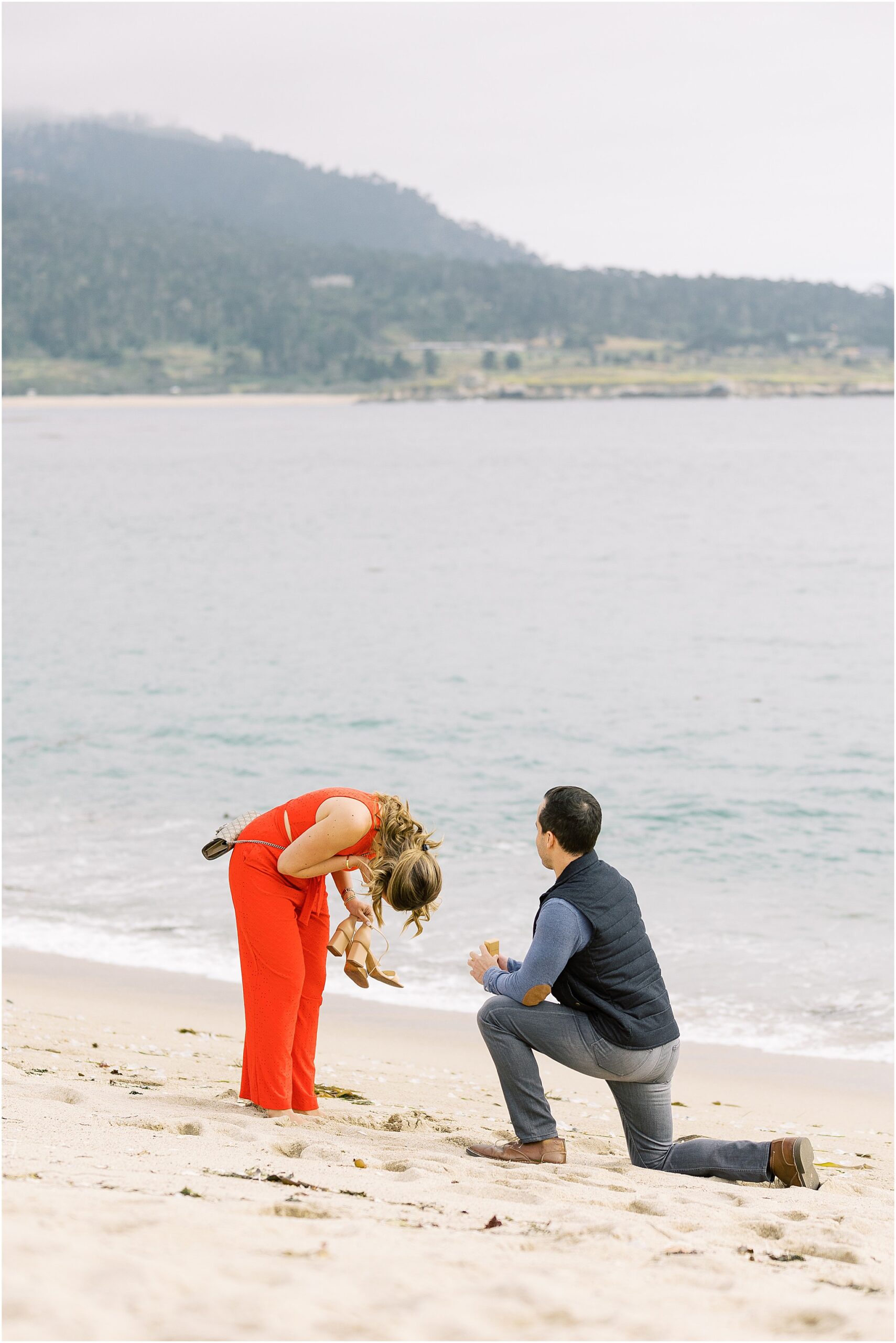 Chaplin kneeling to propose to Nasim on Carmel River Beach at sunset